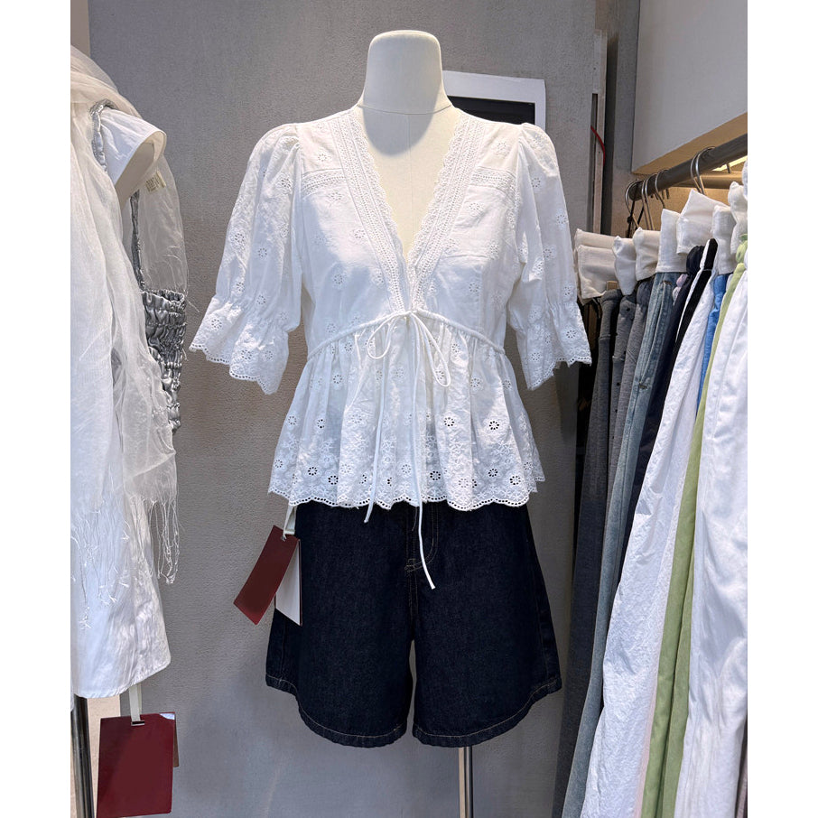 White eyelet embroidered V-neck peplum blouse with lace trim and tie waist