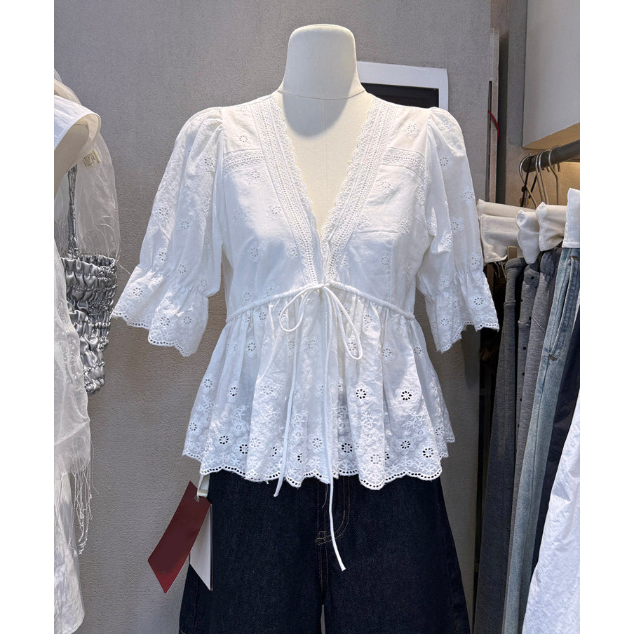 White eyelet embroidered V-neck peplum blouse with lace trim and tie waist